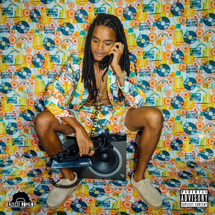 Reggae artist Azizzi Romeo seated with a vintage telephone