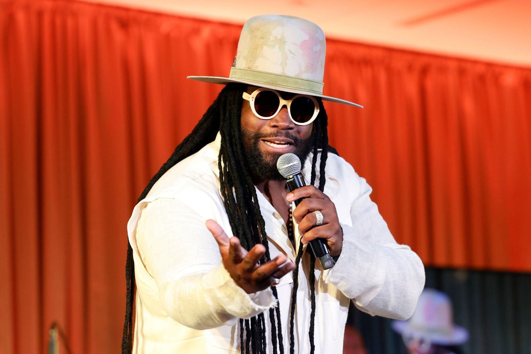 Gramps Morgan of Morgan Heritage performing with a microphone